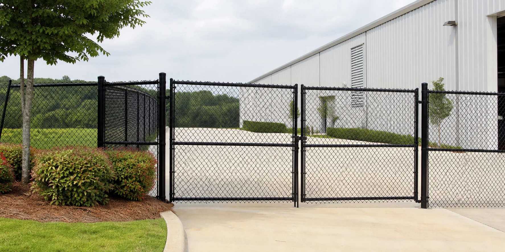 Black vinyl-coated commercial chain-link fence and double gate in Baton Rouge